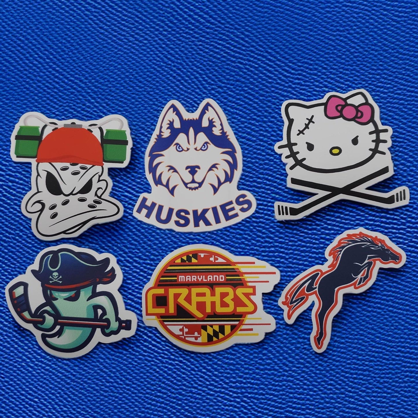 Set of six custom stickers on a blue textured background