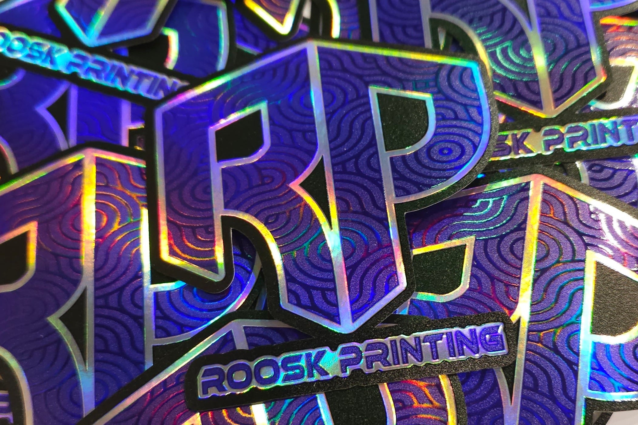 Holographic embossed stickers with 'ROOSK PRINTING' 